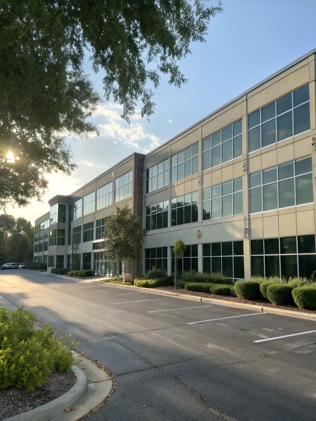 A modern architectural building with a 'For Sale' sign, set against a clear blue sky, showcasing ARH Global Advisors' real estate consulting.
