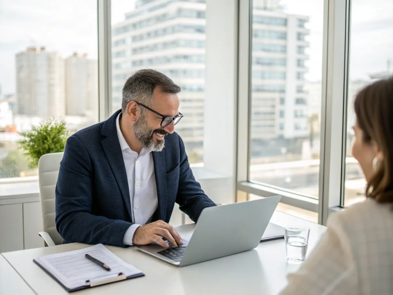 A professional investor is reviewing real estate investment data on a tablet in a modern office setting, with city skyline visible through the window, symbolizing ARH Global Advisors' data-driven approach.