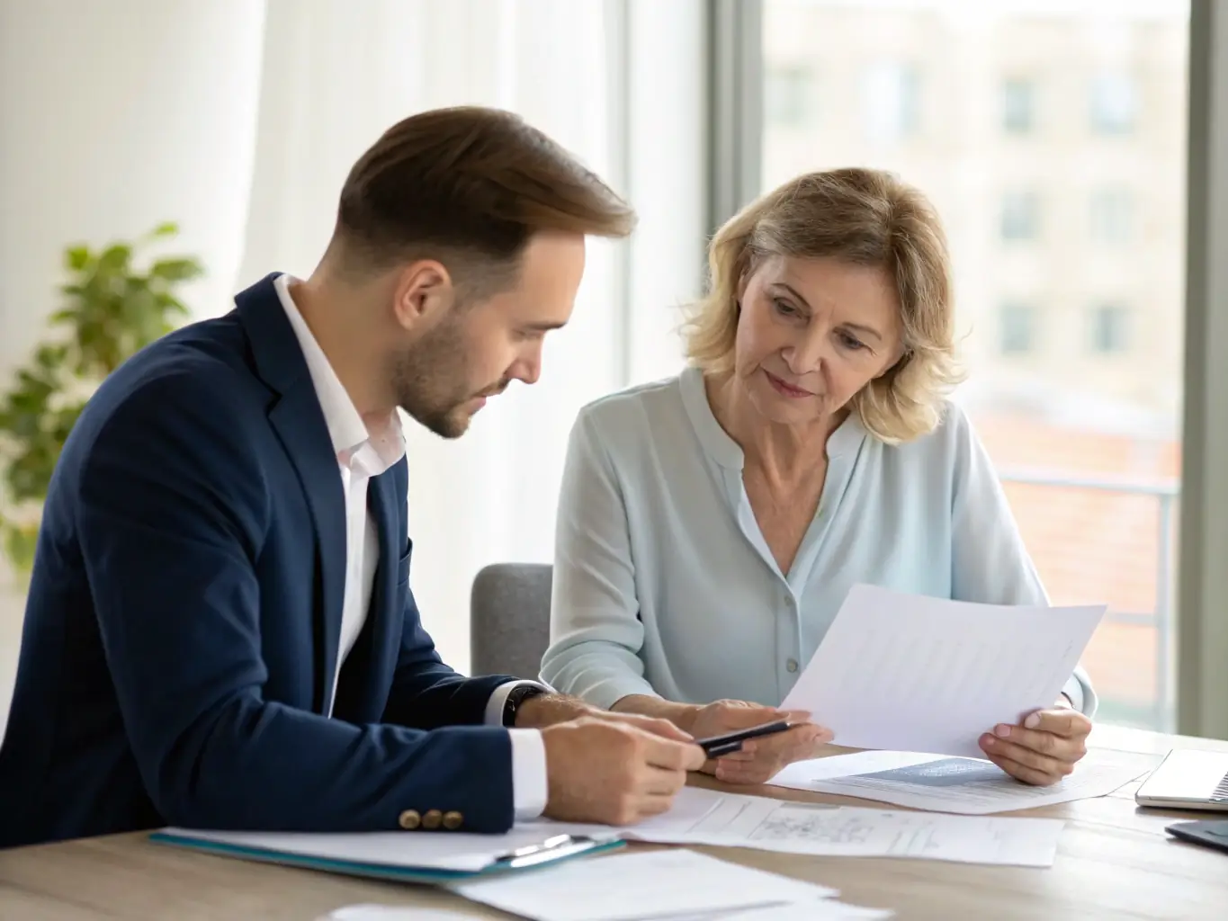 A professional photograph of a Manhattan attorney in their office, reviewing financial documents with a wealth advisor. The scene conveys trust, expertise, and a focus on legal and financial precision.